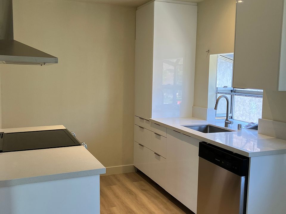 Newly remodeled and updated kitchen featuring tall pantry with pullouts, all base cabinets with drawers, new stainless steel dishwasher, new sink, new quartz countertops. New laminate hardwood floors.