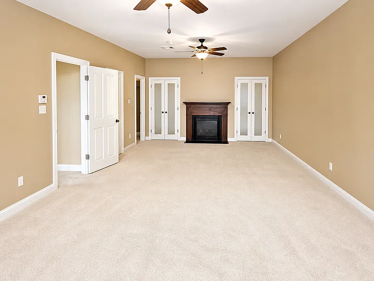 Primary bedroom with faux fireplace.
