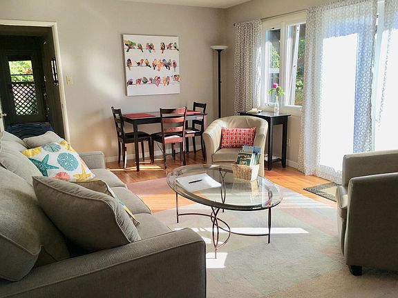 Living room, eating area, and patio doors as seen from the TV corner.