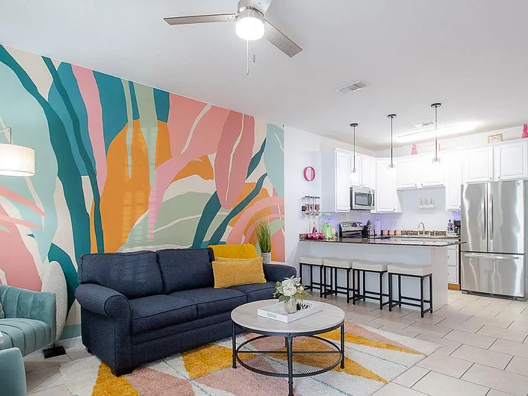 Relax in this tropical-themed living room designed to evoke the vibrant and relaxed atmosphere of a tropical paradise.