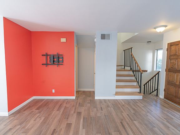 Living room, stairs up to 2 bedrooms each with ensuite bathroom, stairs down to private 2 car garage with laundry and storage