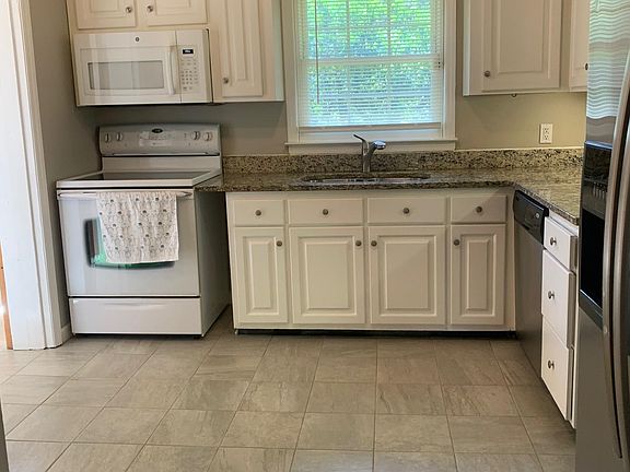 Kitchen - Granite Counter tops and Stainless-Steel sink with Garbage Disposer - Glass Cooktop range - Over the range Microwave