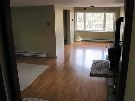 DINING AREA WITH WOOD STOVE .LIVING ROOM AREA IS OFF TO THE LEFT.