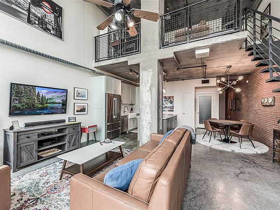 Glass door beyond dining area leads to 2nd bedroom and bathroom. Large open space in living area.