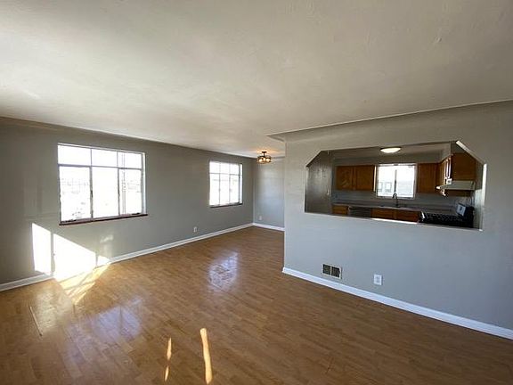 Bright living room is open into kitchen.