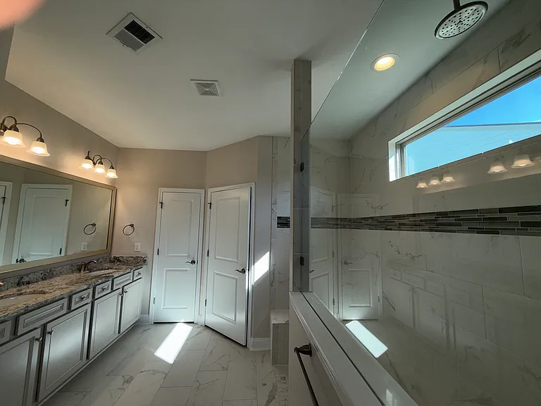 Upgraded Primary Bath with Double Bowl Vanity, Linen Closet and Walk in Shower