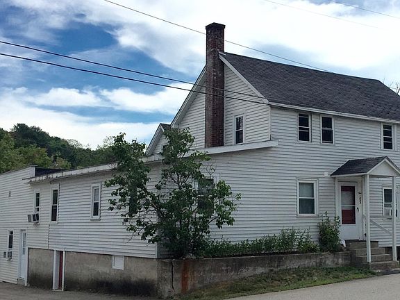 Upstairs apartment has windows on all four sides.