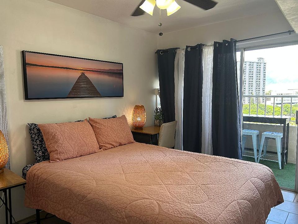 Living area with Queen bed and Patio to Manoa Valley and Ala Wai Canal.