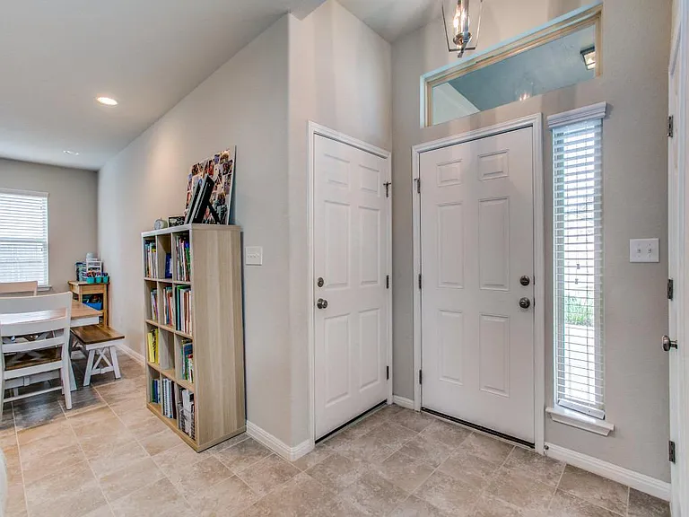 Door to garage on left~ lots windows and natural light - Tile