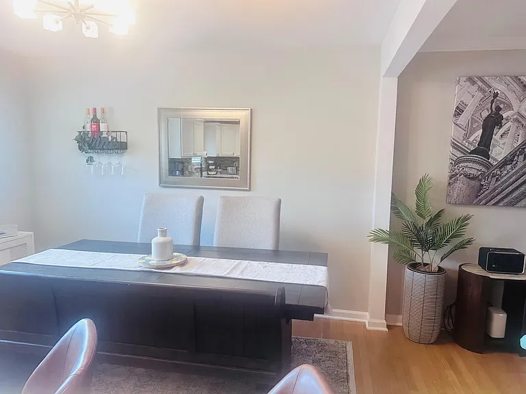 Dining area with a full-size table and cushioned seating, positioned near the kitchen for convenient everyday meals.