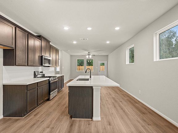 The kitchen features a large center island with overhang perfect for a breakfast bar and overlooks t