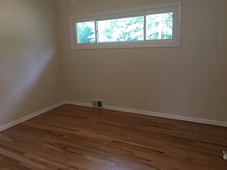 Third bedroom with refinished oak hardwood floors.