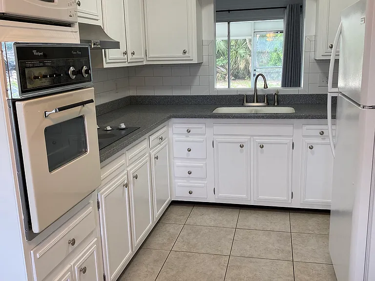 Freshly painted kitchen with corian countertops.