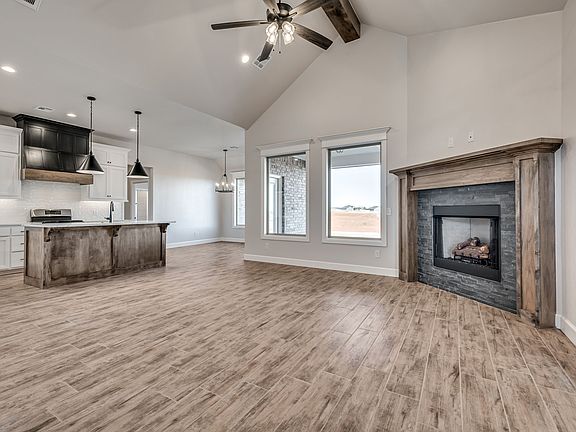 Living room with gas fireplace and vaulted ceiling