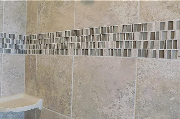 Decorative mosaitrim adorns the master shower