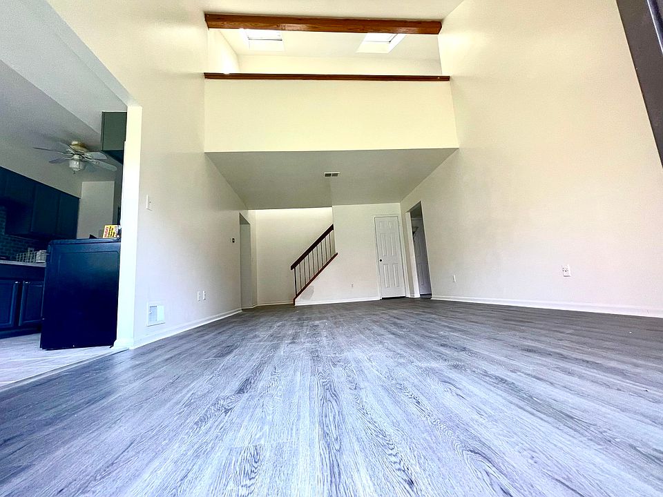 Living area, kitchen to the left. 
looking up at the next level living area/ loft witj skylights