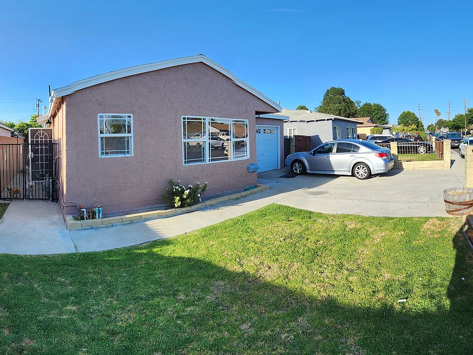 Front of house from left side. Side access gate for rear owner tenants. Small grass area. Newly painted exterior walls. New exterior light fixtures.