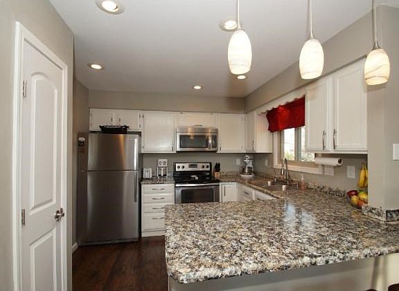Gorgeous kitchen with ss/appliances, white cabinets with updated hardware, new light fixtures and updated counter tops!