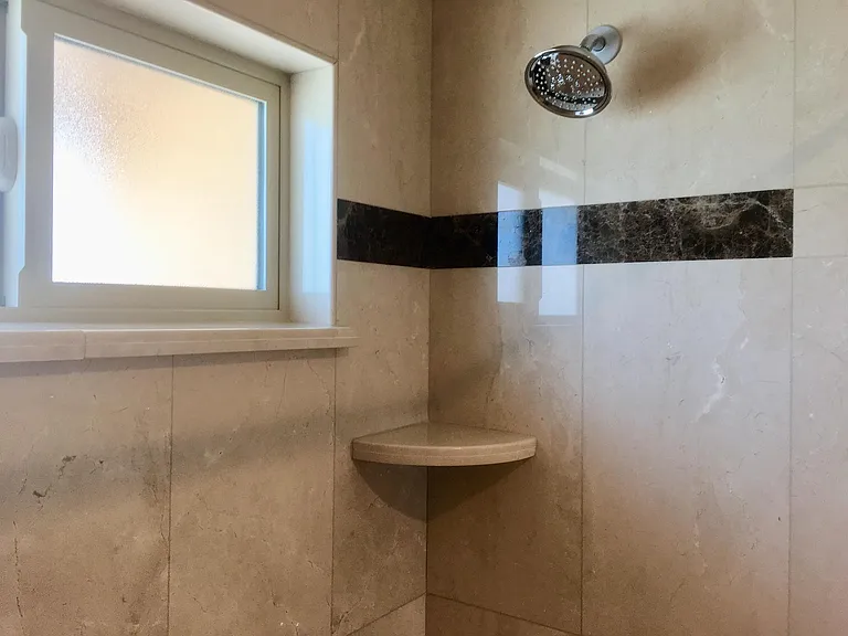DETAILS OF SHOWER TILE IN THE MASTER BATHROOM