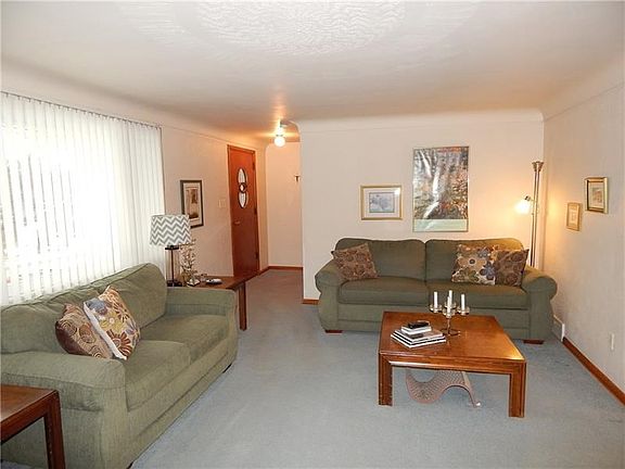 Lots of Natural Sunlight in the Living Room.  There are Hardwood Floors under the carpeting.