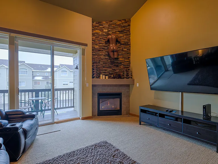 Living room on middle level with 75" Smart TV