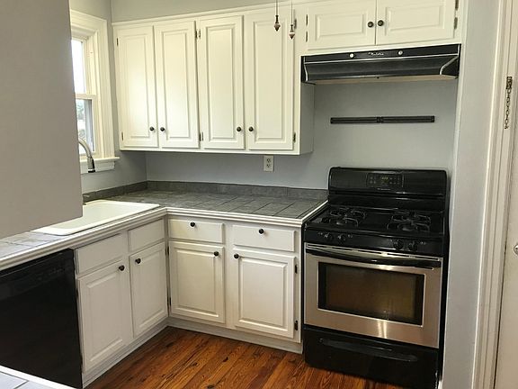 kitchen with lots of storage and large whirlpool refrigerator with ice and ceiling Fan & magnetic bar.