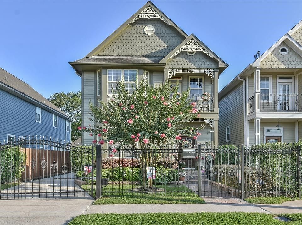 Front exterior with lush landscaping and great curb appeal. Fully gated with driveway access.