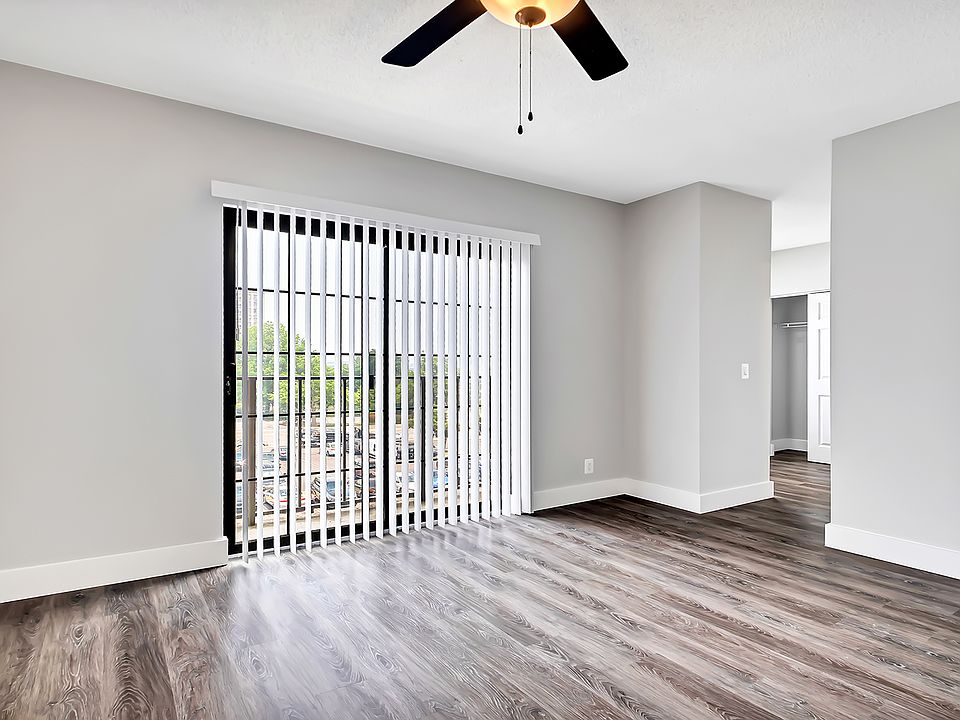 Spacious bedroom with natural lighting and wood flooring throughout