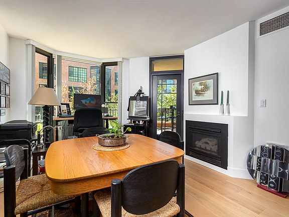 Living room with fire place, floor to ceiling bay window and access to the balcony.