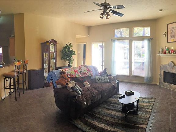 The family room is open and spacious, with 10 foot ceilings, a custom fire place surround and beautiful tile floors