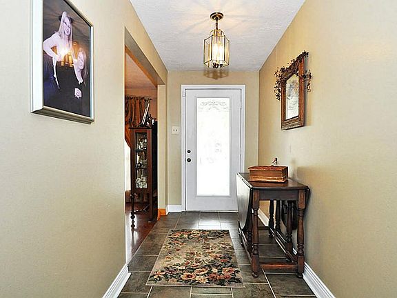 Enter through the leaded glass front door to large tiled entry