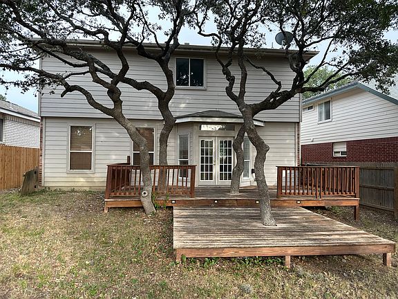 Expansive 20' x 10' deck with an additional 10' x 10' step-down platform_ideal for outdoor entertaining beneath a natural canopy of mature trees.