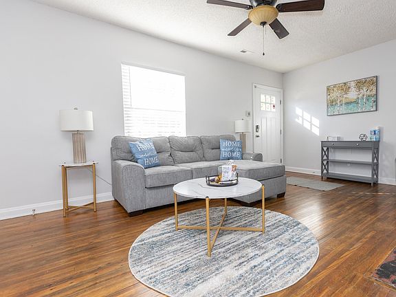 Furnished Family room with comfortable sofa & additional seating