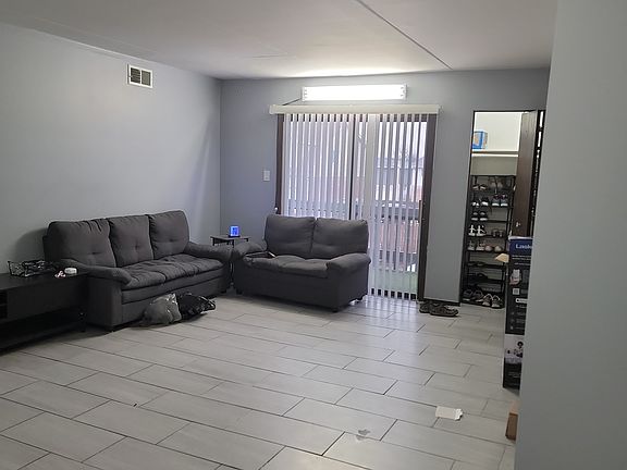 Living room, and balcony outside, coat closet