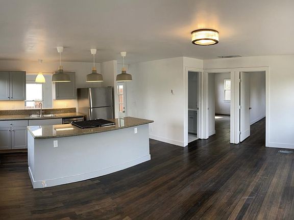 Kitchen & Living room (doors lead to 2 of the bedrooms & 1 of the bathrooms)