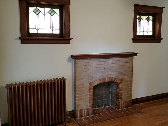 Family Room w/ decorative fireplace and stained glass window