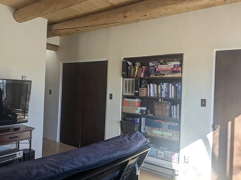 Larger bedroom is set up as a study/ guestroom
