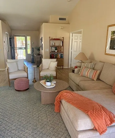 Light & bright living room with spaces to gather and entertain.