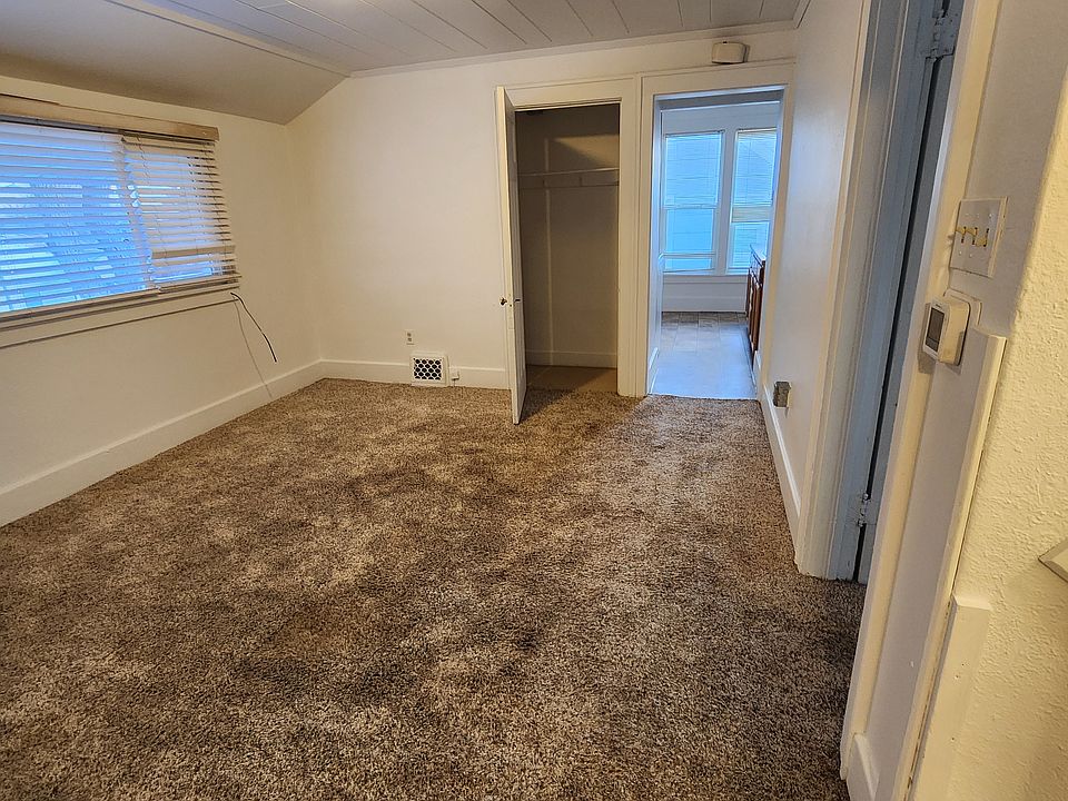 Living room with it's own closet and large window.
The door goes into the kitchen large enough for a 4 person table. 
The windows serve the kitchen nicely for ventilation as needed. 
The bathroom is to the right of the kitchen windows.