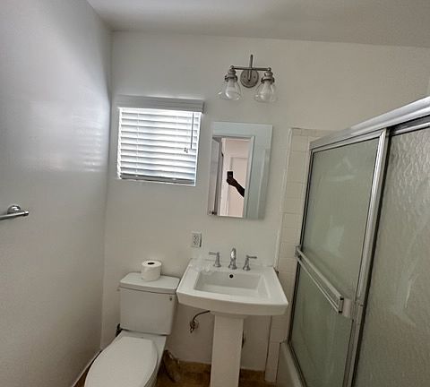 Wonderful bathroom with a pedestal sink, sliding glass doors for your tub and shower.