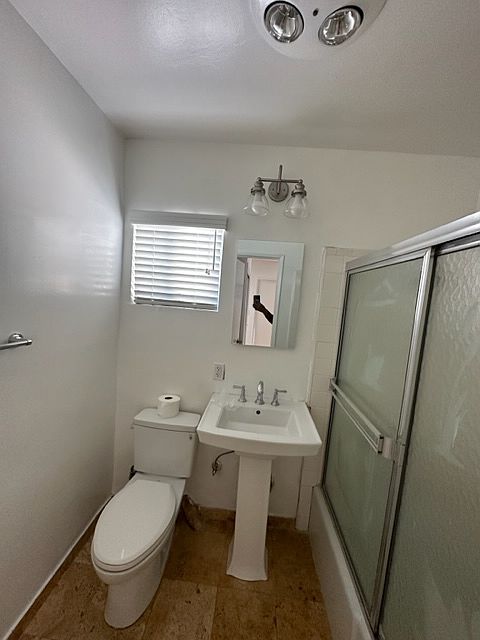 Wonderful bathroom with a pedestal sink, sliding glass doors for your tub and shower.