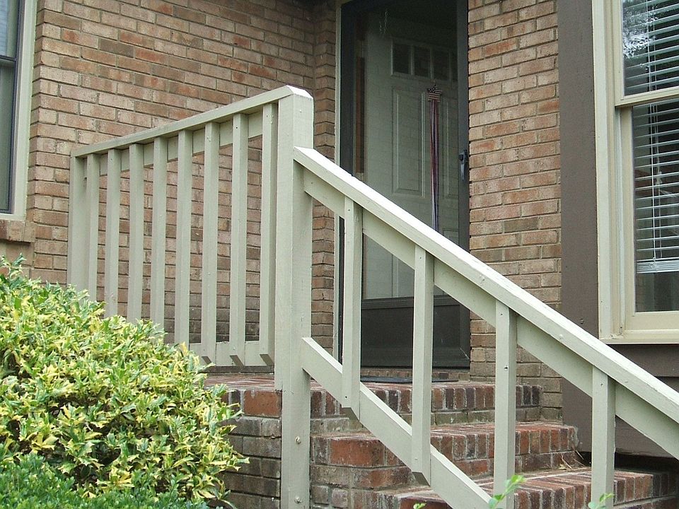Steps to the front door. The home is brick.