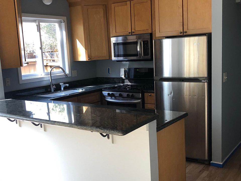 The kitchen has granite countertops and stainless steel appliances