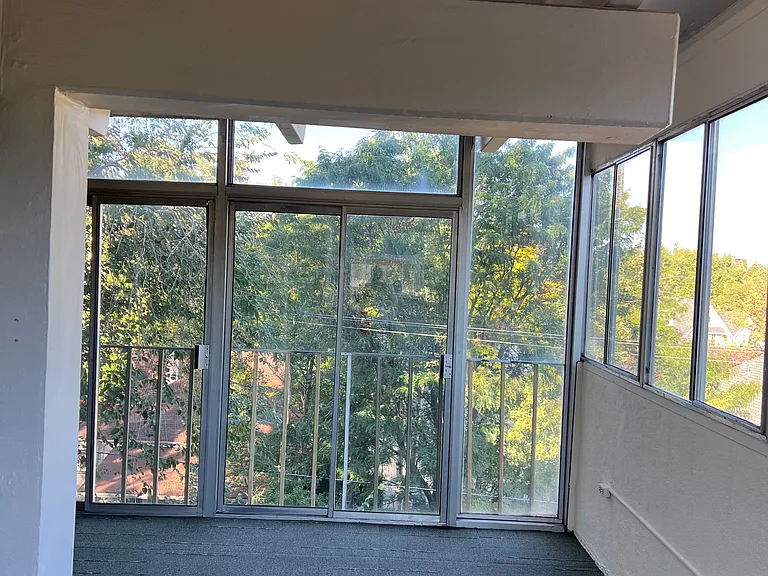 Balcony view to the west. Treetops in the summer and mountain view in winter