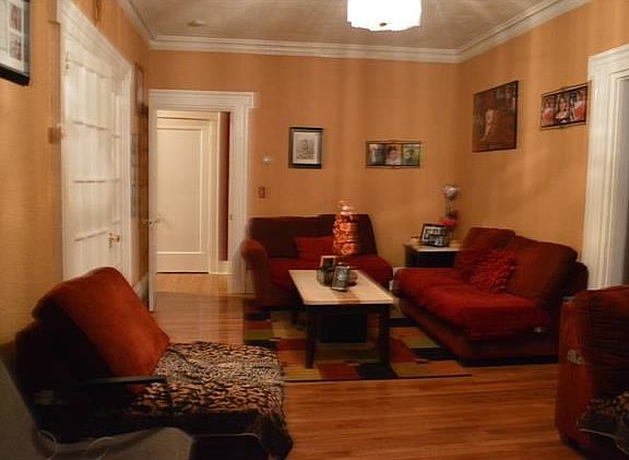 Livingroom for first floor apartment with hardwood floors.