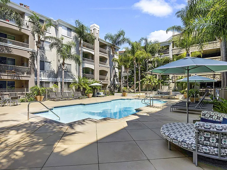 Soak up the sun by the palm-lined pool and relax into your favorite lounge chair.