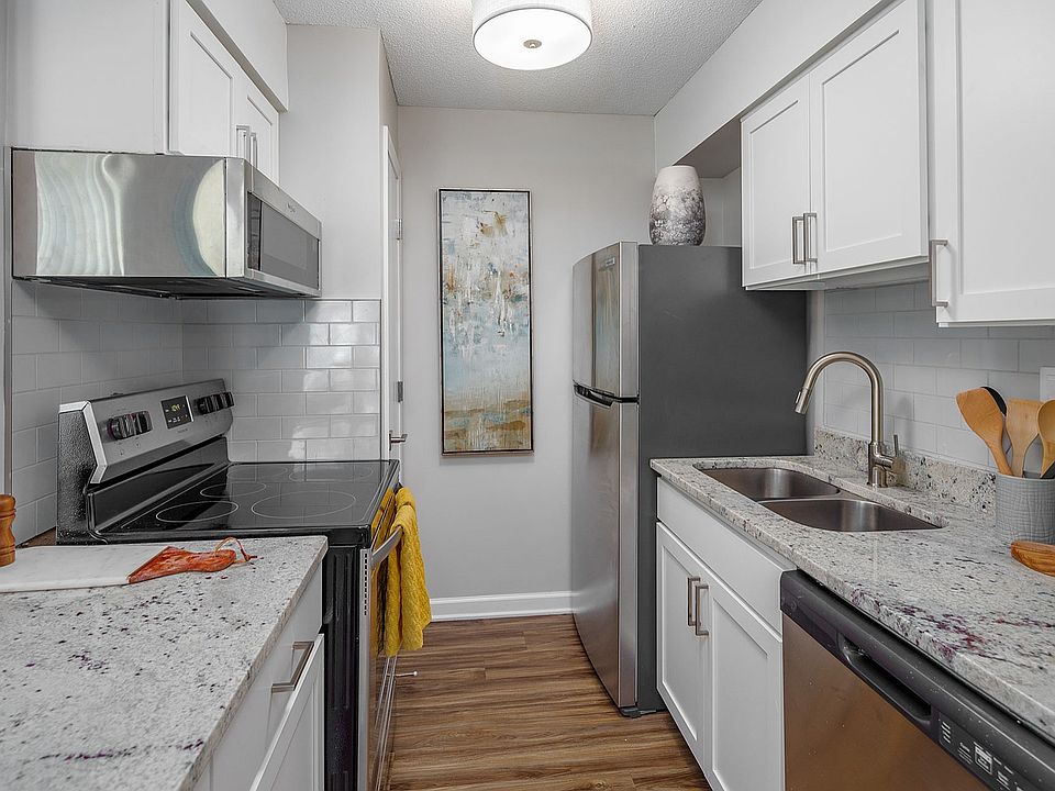 Kitchen with granite counters, stainless appliance package, and subway tile backsplash