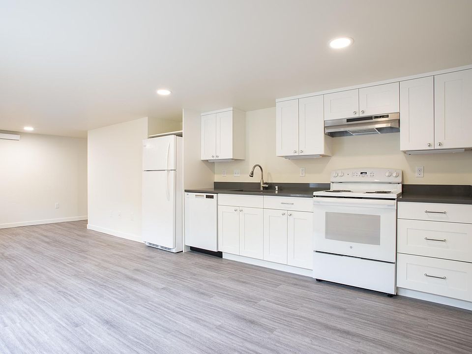 Kitchen + Living Room with glass door and windows on southfacing wall. All new, full-size appliances including dishwasher. Granite countertops. Laminate flooring.