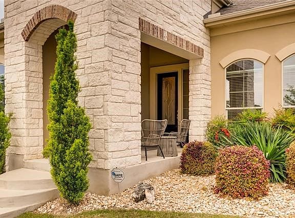Covered patio features a full outdoor kitchen