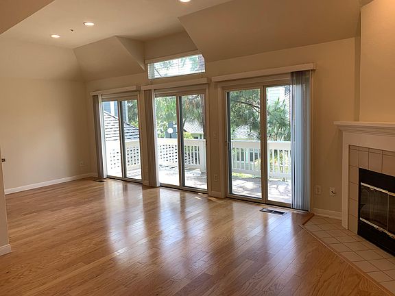Dining and living rooms with fireplace on the right.